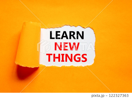 Learn new things symbol. Concept words Learn new things on beautiful white paper. Beautiful orange table orange background. Business motivational learn new things concept. Copy space. 122327363