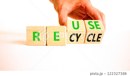 Reuse or recycle symbol. Concept words Reuse Recycle on wooden block. Beautiful white table white background. Businessman hand. Business reuse or recycle concept. Copy space. 122327386