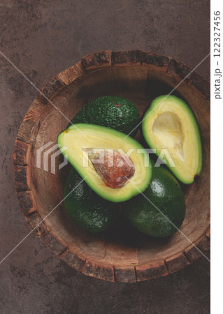 fresh, sliced avocado, in a wooden plate, top view, food background, concept, food styling 122327456