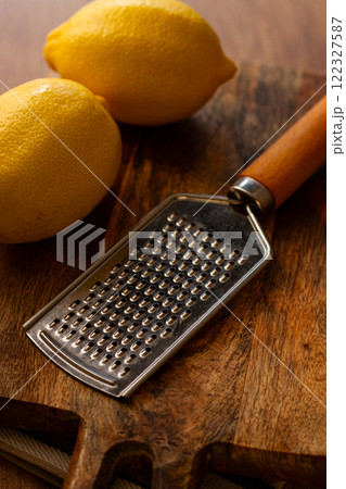 lemons with a zest grater, on a chopping board, close-up, no people, lemons with a zest grater, on a chopping board, close-up, no people, 122327587