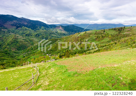 beautiful countryside of ukraine. green environment. cloudy morning. wonderful springtime landscape in mountains. grassy field and rolling hills. rural scenery. scenic view beautiful countryside of ukraine. green environment. cloudy morning. wonderful springtime landscape in mountains. grassy field and rolling hills. rural scenery. scenic view 122328240