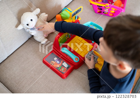 A child is playing store at home. A child is playing store at home. 122328703