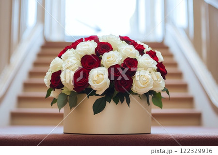 Close-up of a beautiful bouquet featuring red and white roses in a stylish round box 122329916