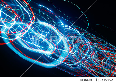 Abstract blurred colorful light effect on a black background. Long exposure photo of moving camera. Abstract blurred colorful light effect on a black background. Long exposure photo of moving camera. 122330492