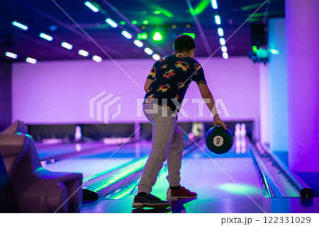 happy young boy child have fun cheering while playing bowling game bowling alley happy young boy child have fun cheering while playing bowling game bowling alley 122331029