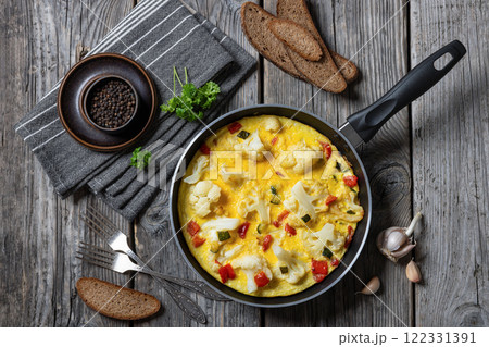 cauliflower, zucchini and red bell pepper frittata cauliflower, zucchini and red bell pepper frittata 122331391
