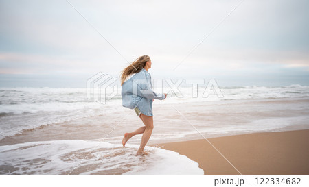 Carefree woman in casualwear running on wet 122334682