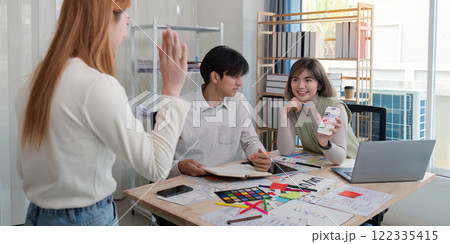 Creative UX UI team collaborating on design project in a modern office, showcasing diverse professionals Creative UX UI team collaborating on design project in a modern office, showcasing diverse professionals 122335415