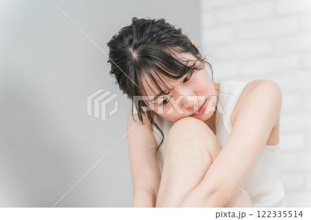 落ち込んで俯く若いアジア人女性（つらい・後悔・失恋・ショック） 122335514