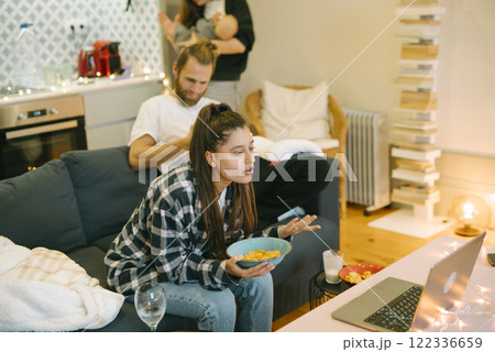 Family Night In Enjoying a Cozy Movie at Home with Snacks for Everyone to Share Family Night In Enjoying a Cozy Movie at Home with Snacks for Everyone to Share 122336659