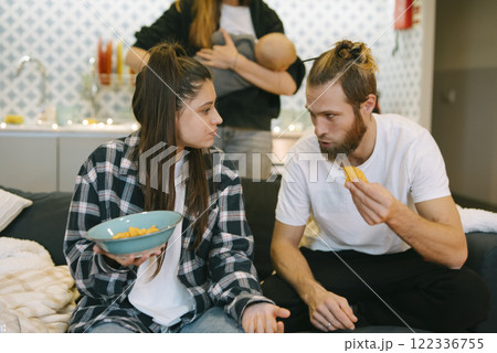 Casual family interactions at home, enjoying delicious snacks, create lasting memories 122336755