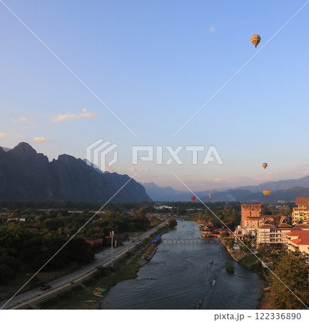 Hot air balloons over the Nam Song River evening scene in Vang Vieng, Laos. Hot air balloons over the Nam Song River evening scene in Vang Vieng, Laos. 122336890