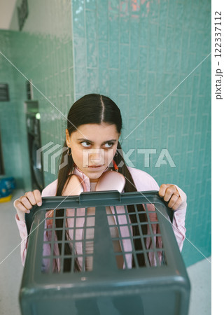 A Teen Girl Appropriately Posing with a Laundry Basket in a Charming Retro Bathroom Setting 122337112