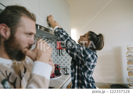 A couple fully engaged in various home repair tasks, followed by enjoyable relaxation activities 122337128