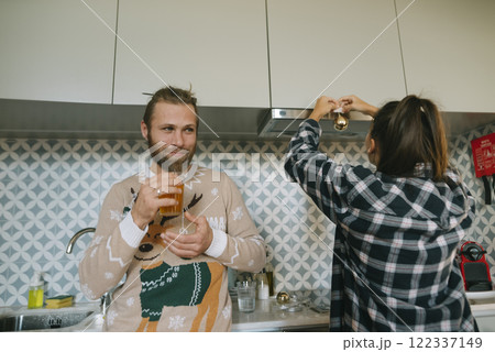 A Couple Happily Enjoying Quality Time Together in Their Cozy and Inviting Kitchen Space 122337149