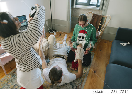 Enjoying a Wonderful Fun Holiday Gathering with Close Friends in a Cozy Living Room Space Enjoying a Wonderful Fun Holiday Gathering with Close Friends in a Cozy Living Room Space 122337214