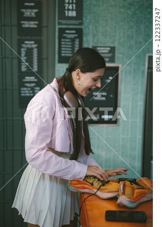 A young woman is actively DJing in a modern and vibrant setup that exudes creativity and fun 122337247