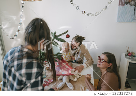 A Happy Family Celebrating Christmas Together, Surrounded by Gifts and a Beautiful Christmas Tree 122337278