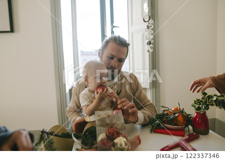 A Father and Child Engaged in Crafting Activities Together in a Cozy Atmosphere Full of Warmth 122337346