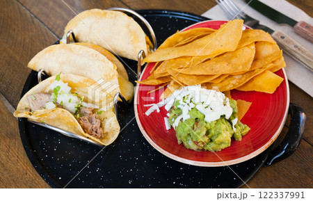 Guacamole with nachos and tacos 122337991