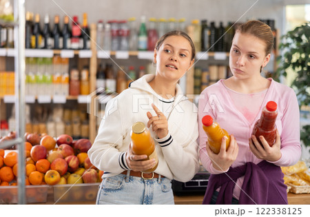 Two customers choose natural juices 122338125