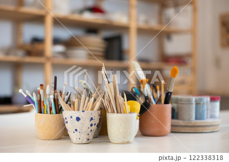 Pottery tools for processing handmade clay work pieces on the table Pottery tools for processing handmade clay work pieces on the table 122338318