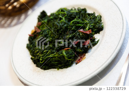 Espinacas a la Catalana served in white plate Espinacas a la Catalana served in white plate 122338729