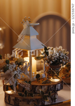 A white lantern with a candle inside is lit up.  122338747