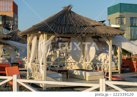 Rows of bungalows on a sandy beach. 122339120