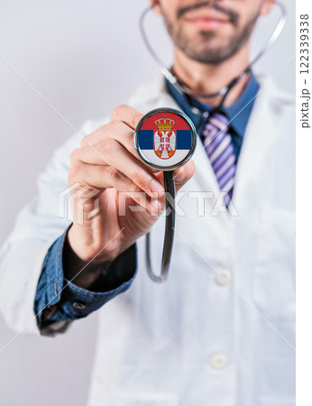 Serbia health and medical insurance concept. Serbia Healthcare System, doctor holding stethoscope Serbia health and medical insurance concept. Serbia Healthcare System, doctor holding stethoscope 122339338