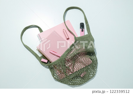 Pink notebook with stationery in a bag 122339512