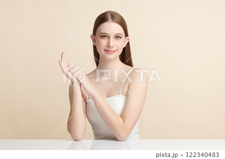 Beautiful young woman with clean fresh skin on beige background, Face care, Facial treatment, Cosmetology, beauty and spa, women portrait. 122340483