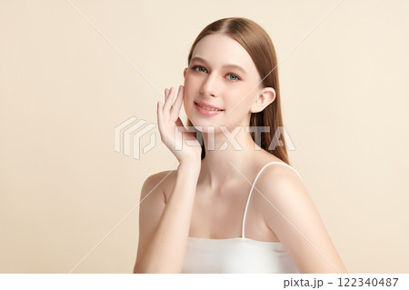 Beautiful young woman with clean fresh skin on beige background, Face care, Facial treatment, Cosmetology, beauty and spa, women portrait. Beautiful young woman with clean fresh skin on beige background, Face care, Facial treatment, Cosmetology, beauty and spa, women portrait. 122340487