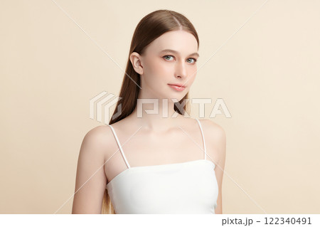 Beautiful young woman with clean fresh skin on beige background, Face care, Facial treatment, Cosmetology, beauty and spa, women portrait. Beautiful young woman with clean fresh skin on beige background, Face care, Facial treatment, Cosmetology, beauty and spa, women portrait. 122340491