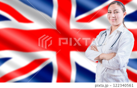 Female doctor on UK flag. Doctor with crossed arms on UK flag. UK Health and Care concept. Female doctor on UK flag. Doctor with crossed arms on UK flag. UK Health and Care concept. 122340561