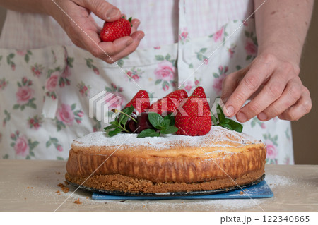 women's hands decorate the cake with berries and mint women's hands decorate the cake with berries and mint 122340865