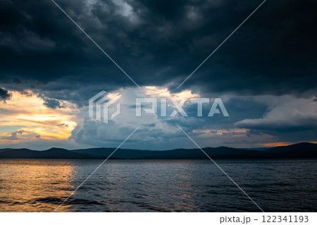 Cloudy evening before rain on a picturesque lake 122341193
