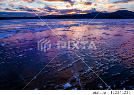 Lake covered with ice against the backdrop of sunrise 122341236