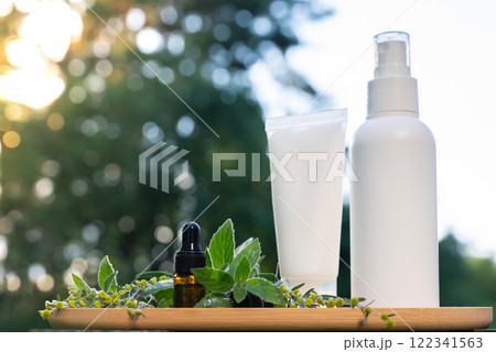 White handmade cosmetic bottles template mockup skin care herbal alternative Insect repellent outdoors during summer. Trying to kill mosquitoes and flies with organic ingredients mint extract oil 122341563