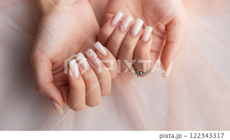 Female hands with fashionable ombre manicure on pink background Female hands with fashionable ombre manicure on pink background 122343317