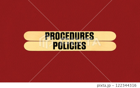 Concept word Procedures and Policies on beautiful wooden stick. Beautiful Red Chart Paper Background. Business and Procedures and Policies concept. Copy space Concept word Procedures and Policies on beautiful wooden stick. Beautiful Red Chart Paper Background. Business and Procedures and Policies concept. Copy space 122344316