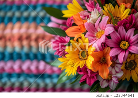 Colorful bouquet of flowers resting on a handmade crocheted blanket Colorful bouquet of flowers resting on a handmade crocheted blanket 122344641
