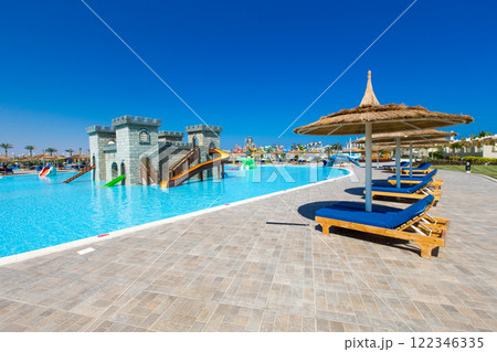swimming pool with coconut tree and white umbrella 122346335