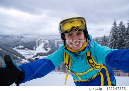 Smiling Skier on Snowy Slope Smiling Skier on Snowy Slope 122347278