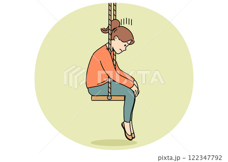 Upset little girl sits on swing with head down after parents divorce or reprimand at school 122347792