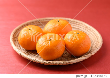 Mandarin tangerine orange fruit on red background, Lucky food in Lunar New Year or Chinese New Year Mandarin tangerine orange fruit on red background, Lucky food in Lunar New Year or Chinese New Year 122348139