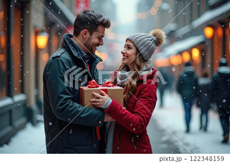 young loving couple with a gift box on valentines day outdoors young loving couple with a gift box on valentines day outdoors 122348159