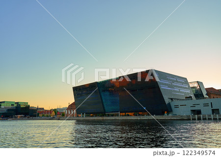 Exterior of Royal Library in Copenhagen. Facade of national library of Denmark known as the Black Diamond at sunset. Modern architecture in city 122349574