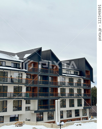 New modern block of flats in green area at winter. residential apartment with flat buildings exterior. luxury house complex covered snow. City Real estate property condo architecture insurance concept New modern block of flats in green area at winter. residential apartment with flat buildings exterior. luxury house complex covered snow. City Real estate property condo architecture insurance concept 122349891
