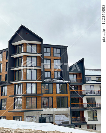 New modern block of flats in green area at winter. residential apartment with flat buildings exterior. luxury house complex covered snow. City Real estate property condo architecture insurance concept New modern block of flats in green area at winter. residential apartment with flat buildings exterior. luxury house complex covered snow. City Real estate property condo architecture insurance concept 122349892